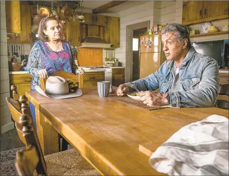  ?? Yana Blajeva Lionsgate ?? SYLVESTER STALLONE’S John Rambo tries to kick back at an Arizona ranch. His surrogate family includes Adriana Barraza’s Maria.