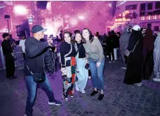  ?? ?? People pose for pictures during the Balad Beast music festival in Jeddah’s oldest neighbourh­ood, known as Al-Balad.