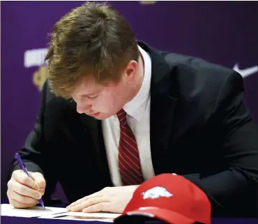  ?? PATRICK LANTRIP — THE ASSOCIATED PRESS ?? Arkansas commit Patrick Kutas Jr. signs his letter of intent Wednesday at Christian Brothers HS in Memphis, Tenn.