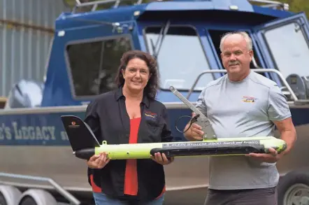  ?? MARK HOFFMAN / MILWAUKEE JOURNAL SENTINEL ?? Keith Cormican (right) and Beth Darst hold a towed sonar device in Black River Falls. Cormican runs Bruce’s Legacy, a nonprofit dedicated to locating the bodies of drowning victims. See more photos and a video at jsonline.com/news.