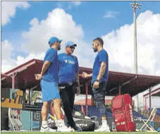  ?? PTI PHOTO ?? (From left) MS Dhoni, coach Anil Kumble and Virat Kohli have a chat ahead of a team practice session on Friday.