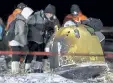  ?? Ren Junchuan, Xinhua via The Associated Press ?? Recovery crew members retrieve the capsule of the Chang’e 5 probe after its successful landing Thursday in Siziwang, China.