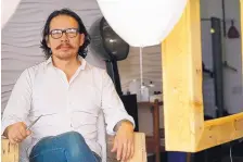  ?? ADOLPHE PIERRE-LOUIS/JOURNAL ?? Entreprene­ur Nam Tran, who fled Vietnam to the United States with his mother as a young boy, sits inside his Nob Hill hair salon, which he opened a year ago. He has two other hair salon locations as well as a restaurant that opened this summer.