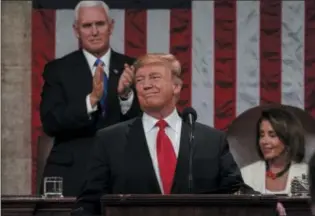  ?? DOUG MILLS—ASSOCIATED PRESS ?? In this Feb. 5, 2019photo, President Donald Trump gives his State of the Union address to a joint session of Congress, at the Capitol in Washington, as Vice President Mike Pence, left, and House Speaker Nancy Pelosi look on.