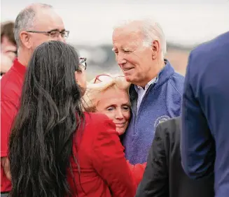  ?? Evan Vucci/Associated Press ?? Rep. Debbie Dingell, D-Mich., hugs President Joe Biden as he arrives at Detroit Metropolit­an Wayne County Airport to join striking United Auto Workers on the picket line, Tuesday in Romulus, Michigan.