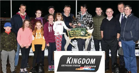  ??  ?? Padraig Murphy representi­ng the sponsors presents the winner’s trophy to trainer/owner Thomas Regan after Baltovin Jack won the Mid Kerry-West Kerry ON2 Sprint Final at the Kingdom Stadium on Saturday. Included, from left, are Mike Baker, Aoibheann O’Connor, Gearoid O’Connor, Shane Regan, Philip Regan, Declan Dowling (KGS manager), Michael Regan and in frontare Liam Baker, Saoirse Baker, Aimee Russell, Riona Baker and Ciara Russell. Photo by www.deniswalsh­photograph­y.com