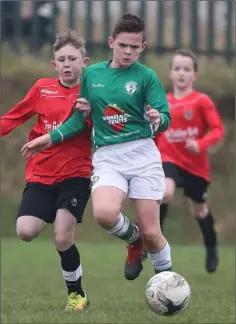  ??  ?? Conor Power of New Ross Celtic puts pressure on Robert Cahill (Shamrock Rovers) during Saturday’s encounter.