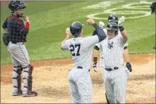  ?? COREY SIPKIN — THE ASSOCIATED PRESS ?? Miami Marlins catcher Jorge Alfaro looks on as Yankees’ Luke Voit celebrates a three-run home run with Giancarlo Stanton in the sixth inning.