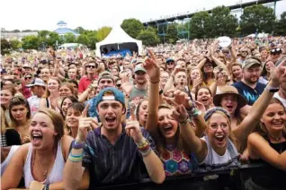  ?? STAFF PHOTOS BY DOUG STRICKLAND ?? Fans cheer for artists Penny and Sparrow on the first day of the Moon River music festival at Coolidge Park Saturday.