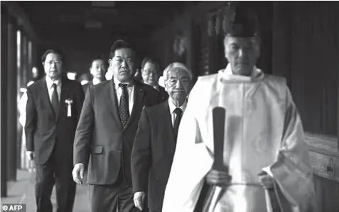  ?? AGENCE FRANCE PRESSE ?? Japanese lawmakers visited Yasukuni Shrine, a controvers­ial spot that honors millions of war dead, including senior war criminals.