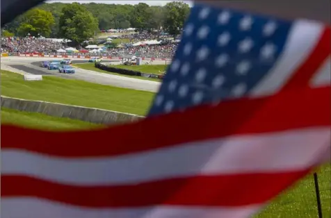  ?? Associated Press ?? NASCAR celebrated the Fourth of July at Road America, while Chase Elliott celebrated another road course win.