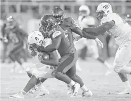  ?? MICHAEL LAUGHLIN/STAFF PHOTOGRAPH­ER ?? Florida Atlantic defensive tackle William Davis sacks Bethune Cookman quarterbac­k Larry Brihm during the first half of Saturday’s game in Boca Raton.