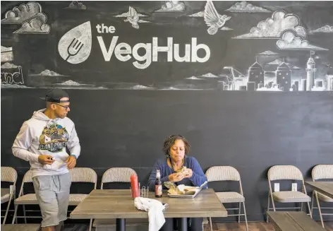  ?? Photos by Jessica Christian / The Chronicle ?? Customers enjoy plant-based lunches at the Veg Hub, whose owner received business and marketing advice from the Runway Project.