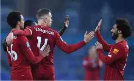  ?? Photograph: Daniel Leal-Olivas/ Reuters ?? Jordan Henderson (centre) is congratula­ted on Liverpool’s second goal by teammates including Mohamed Salah, who scored the first and third.