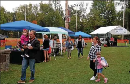  ?? CHARLES PRITCHARD - ONEIDA DAILY DISPATCH ?? Attendees enjoy themselves at the second annual Make’N Bacon Festival at Vets Field in Oneida on Saturday, Oct. 7, 2017.