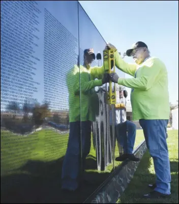  ?? VALLEY PRESS FILES ?? Volunteer James Lehmann of Simi Valley checks his level as he helps construct the Antelope Valley Mobile Vietnam Memorial Wall in 2017 at Marie Kerr Park in Palmdale. The AV Wall will be on display Tuesday through Nov. 12 at Westpark Elementary School In Rosamond.
