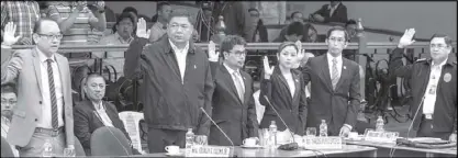  ?? GEREMY PINTOLO ?? Bureau of Immigratio­n Commission­er Jaime Morente (right) takes his oath during yesterday’s Senate probe on the Jack Lam bribery scandal along with (from left) former BI associate commission­er Al Argosino, former executive assistant Charles Calima and...