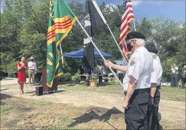  ?? RACHEL RAVINA — MEDIANEWS GROUP ?? Ocean County College Professor Sungii Kim, left, sings the national anthems of the United States and Republic of Korea as veterans stand at attention Saturday morning during the unveiling of the Korean War Memorial and American-Korean Alliance Peace Park in North Wales.