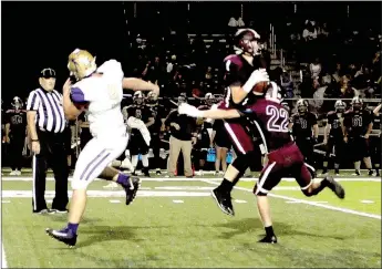  ?? MARK HUMPHREY ENTERPRISE-LEADER ?? Lincoln senior Sterling Morphis makes a leaping intercepti­on of a pass intended for Berryville’s Ethan Gregory (No. 9) while Morphis’ teammate Blake Arnold (No. 22) tries to avoid dislodging the ball. Morphis hung on and returned the pick 42 yards to set up a Wolf touchdown during Lincoln’s 41-7 Homecoming victory over the Bobcats on Friday, Oct. 5.