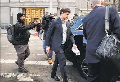  ?? Julie Jacobson / Associated Press ?? Gordon Caplan, of Greenwich, center, walks out of federal court in New York City on Tuesday. Fifty people, including Hollywood stars Felicity Huffman and Lori Loughlin, were charged in an admissions bribery scheme.