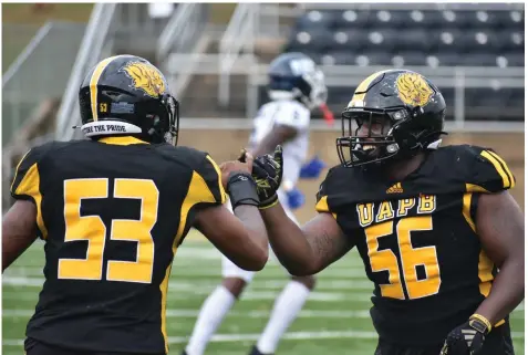  ?? Commercial/I.C. Murrell) (Pine Bluff ?? UAPB edge rushers Khalil Arnold (left) and Elijah Jenkins (right) share a fist bump after a play at Saturday’s football game against Jackson State at Simmons Bank Field.