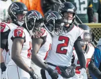  ?? MIKE ROEMER THE ASSOCIATED PRESS ?? Despite the team’s 4-9 record, the Atlanta Falcons and quarterbac­k Matt Ryan, second right, are still in the playoff race.