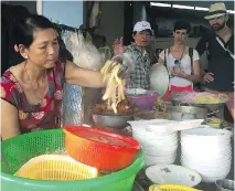  ?? PHOTOS: LIANE FAULDER ?? Clockwise from top: A restaurant in the Old Quarter of Hanoi makes hot pot a specialty; a street-food vendor tends his brazier in the Hang Be market in the Old Quarter; vendors serve Vietnamese snacks long after the sun goes down in Hoi An, a beach...