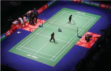  ?? PIC COURTESY OF BWF ?? A court is being cleaned before a training session for the All England in Birmingham yesterday.