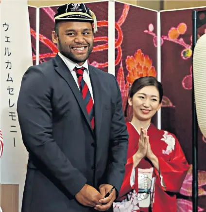  ??  ?? If the cap fits: Billy Vunipola receives his World Cup cap during England’s official welcome to the tournament yesterday