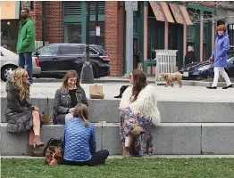  ?? THE ASSOCIATED PRESS ?? Workers take a lunch break on the Rose Fitzgerald Kennedy Greenway Friday in Boston.