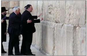  ?? AP/ABIR SULTAN ?? Secretary of State Mike Pompeo touches the Western Wall in Jerusalem’s Old City on Thursday. Pompeo, who is on a multinatio­n visit to the Middle East, called the Golan Heights “that hard-fought real estate, that important place, is proper to be a sovereign part of the state of Israel,” and said President Donald Trump made a “bold decision” to recognize Israel’s authority over the region.
