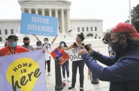  ?? Chip Somodevill­a / TNS 2020 ?? Advocates for immigrants in the Deferred Action for Childhood Arrivals, or DACA, program rally in front of the U.S. Supreme Court in June.