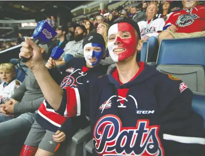  ?? TROY FLEECE ?? Tyler Broley, right, and his 11-year-old son, Connor, cheer on the Regina Pats during Friday’s game against the Moose Jaw Warriors at the Brandt Centre. The Pats won that contest 3-2, scoring as many goals as the Warriors had shots in the first period, with two.