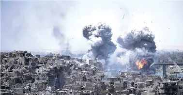  ?? FELIPE DANA/THE ASSOCIATED PRESS ?? Airstrikes target Islamic State positions in July on the edge of the Old City in Mosul, Iraq. Iraq said Saturday that its war on the Islamic State is over after more than three years of combat operations drove the extremists from all of the territory...