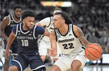  ?? ERIC CANHA/USA TODAY SPORTS ?? Providence guard Devin Carter drives to the basket against Georgetown guard Jayden Epps during the first half at Amica Mutual Pavilion on Saturday.