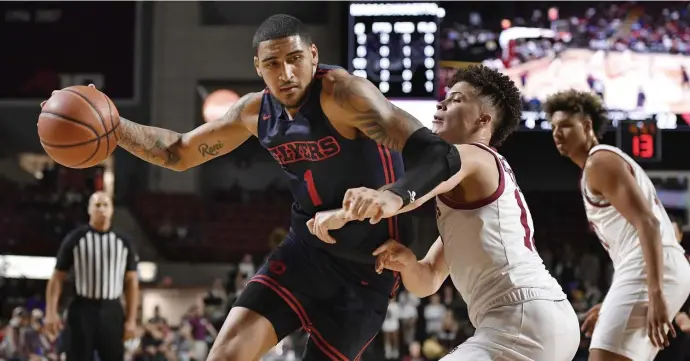  ?? AP ?? FLYERS TAKING OFF: Dayton's Obi Toppin (left) battles against UMass' Kolton Mitchell in the first half of their game Saturday at the Mullins Center.