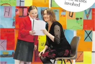  ??  ?? Catherine Ann Cullen, writer in residence supported by A&L Goodbody, with a pupil from St Joseph’s
