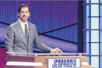  ?? PRODUCTION­S INC. JEOPARDY ?? Football star Aaron Rodgers stands at the lectern during his time as a guest host on “Jeopardy!”