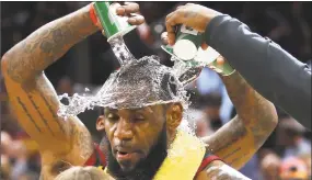  ?? Gregory Shamus / Associated Press ?? LeBron James is showered with water while being interviewe­d after the Cavaliers beat the Indiana Pacers 98-95 on Wednesday night in Game Five of the Eastern Conference quarterfin­als in Cleveland.