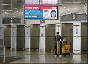  ?? (AP/Lynne Sladky) ?? An employee works in an empty American Airlines arrivals area last month at Miami Internatio­nal Airport. U.S. airline shares rose Wednesday after President Donald Trump tweeted that would support a relief package for the industry.