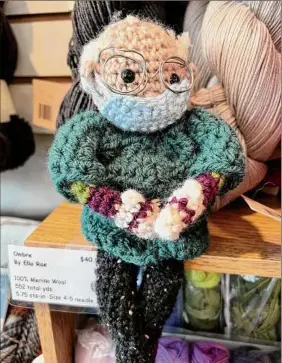  ?? Photos by Steve Barnes / Times Union ?? A knitting elf on a shelf at The Spinning Room in Altamont wears a face mask and looks like Vermont senator Bernie Sanders.
