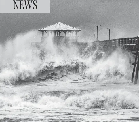  ?? TRAVIS LONG / THE NEWS & OBSERVER VIA AP ?? Waves slam the Oceana Pier and Pier House Restaurant in Atlantic Beach, N.C., on Thursday as hurricane Florence approaches the area.