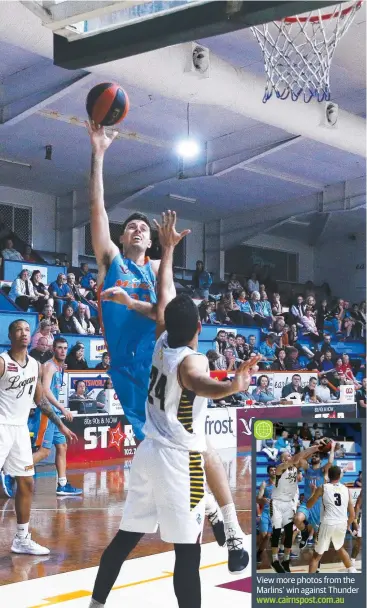  ?? Picture: BRENDAN RADKE ?? FORCE: Marlin's George Blagojevic soars over Thunder's Michael Ceder in the QBL match between the Cairns Marlins and Logan Thunder,.