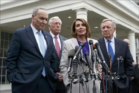  ?? Evan Vucci/Associated Press ?? Speaker of the House Nancy Pelosi, D-Calif., center, speaks to reporters after meeting with President Donald Trump about border security Friday. From left, Senate Minority Leader Chuck Schumer, D-N.Y.; House Majority Leader Steny Hoyer, D-Md.; and Sen. Dick Durbin, D-Ill.