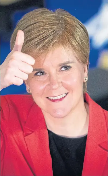  ??  ?? UPBEAT: SNP leader Nicola Sturgeon, above, and a triumphant Angus Robertson, left. The SNP picked up key seats but still faces a number of potential banana skins.