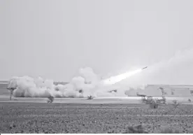  ?? AP/MOSA’AB ELSHAMY ?? A LAUNCH truck fires the High Mobility Artillery Rocket System (HIMARS) at its intended target during the African Lion military exercise in Grier Labouihi complex, southern Morocco, on June 9, 2021. Ukraine has received about a dozen American-built HIMARS multiple rocket launchers and has used them to strike Russian ammunition depots, which are essential for maintainin­g Moscow’s edge in firepower.