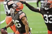  ?? ASSOCIATED PRESS ?? Browns safety Ronnie Harrison taps cornerback M.J. Stewart Jr. on the helmet after Stewart intercepte­d a pass against the Steelers in the regular-season finale. The defense made some big plays but regressed in some categories from 2019. The return from injury of defensive backs Greedy Williams and Grant Delpit is expected to help in 2021.