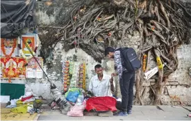  ?? — AP photos ?? NEW DELHI: An Indian man buys a packet of cigarette from a roadside vendor.