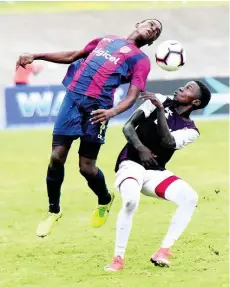  ??  ?? St Andrew Technical High School’s Romario Campbell (left) tries to win a header ahead of Wolmer’s Boys School’s Ty McKetty during their ISSA/Digicel Manning Cup semi-final match at the National Stadium in St Andrew, yesterday.