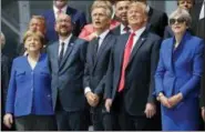  ?? PABLO MARTINEZ MONSIVAIS — THE ASSOCIATED PRESS ?? Looking up in sky during a ceremonial fly-over ahead of the opening ceremony of the NATO (North Atlantic Treaty Organizati­on) summit in Brussels on Wednesday are, from left, German Chancellor Angela Merkel, Belgium’s Prime Minister Charles Michel, NATO Secretary General Jens Stoltenber­g, President Donald Trump and Britain’s Prime Minister Theresa May.